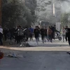 Người Palestine trong cuộc đụng độ với các lực lượng Israel tại Jenin, Bờ Tây ngày 26/1/2023. (Ảnh: THX/TTXVN)