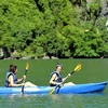 Du khách trải nghiệm chèo thuyền kayak, thuyền tay trên Vịnh Hạ Long. (Ảnh: Thanh Vân/TTXVN)