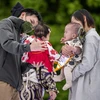 Cha mẹ cho các con tham gia một trò chơi ở Tokyo, Nhật Bản ngày 22/4/2023. (Ảnh: AFP/TTXVN)