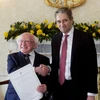 Tổng thống Ireland Michael D. Higgins (trái) và Thủ tướng Simon Harris tại Dublin, ngày 9/4/2024. (Ảnh: AFP/TTXVN)