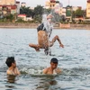 Trước thời tiết nắng nóng kỷ lục ở Hà Nội, người dân đã tận dụng hồ Linh Đàm làm nơi 'giải nhiệt' vì tiện lợi, nhanh chóng và không mất chi phí nào. (Ảnh: Minh Sơn/Vietnam+)