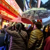 Hàng trăm người dân đã đội mưa xếp hàng từ sớm tại các điểm bán vàng ở Hà Nội để mua vàng nhân ngày Thần tài. (Ảnh: Minh Sơn/Vietnam+)
