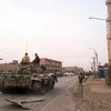 Các binh sĩ ủng hộ lực lượng Chính phủ Syria tuần tra tại thị trấn Albu Kamal, Syria. (Nguồn: AFP/TTXVN)