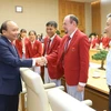Thủ tướng Nguyễn Xuân Phúc và các Huấn luyện viên, vận động viên xuất sắc của Đoàn thể thao Việt Nam tham dự ASIAD 18. (Nguồn: Thống Nhất/TTXVN)