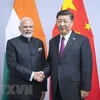 Thủ tướng Ấn Độ Narendra Modi (trái) và Chủ tịch Trung Quốc Tập Cận Bình (phải) tại một cuộc gặp. (Nguồn: THX/TTXVN)