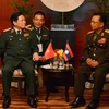 Bộ trưởng Bộ Quốc phòng, Đại tướng Ngô Xuân Lịch hội đàm với Bộ trưởng Quốc và Đại tướng, Bộ trưởng Quốc phòng Lào Chansamon Chanyalat. (Ảnh: Ngọc Quang/TTXVN)