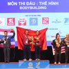Cặp đôi vận động viên Việt Nam giành huy chương vàng nội dung nam nữ ở môn Thể hình tại SEA Games 31. (Ảnh: PV/Vietnam+)