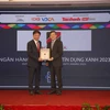 Ông Vũ Viết Ngoạn – nguyên Chủ tịch Ủy ban giám sát Tài chính Quốc gia (phải) trao giải thưởng cho đại diện Agribank. (Ảnh: Vietnam+)