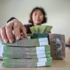 Luật Các tổ chức tín dụng giới hạn trần sở hữu mới tại một ngân hàng. (Ảnh: PV/Vietnam+)