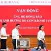 Cán bộ, người lao động Agribank toàn hệ thống quyên góp ủng hộ khắc phục hậu quả cơn bão số 3. (Ảnh: Vietnam+)