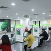 Các đại biểu Quốc hội nhất trí chủ trương bổ sung vốn điều lệ cho Vietcombank. (Ảnh: Vietnam+)