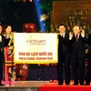 Phó Thủ tướng Nguyễn Sinh Hùng trao cờ Năm du lịch quốc gia 2010 cho Chủ tịch UBND thành phố Hà Nội Nguyễn Thế Thảo. (Ảnh: Thanh Hà/TTXVN)