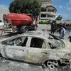 Chiếc xe bị phá hủy tại trường học của Mỹ ở thủ đô Tunis, Tunisia ngày 14/9. (Ảnh: AFP/TTXVN)