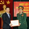 Trung tướng Đào Duy Minh trao tặng Phó Thủ tướng Xổmxavạt Lềnhxavắt bộ sách quý. (Ảnh: Trọng Đức/TTXVN)