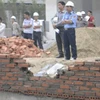 Bức tường vừa xây lại tiếp tục bị xô đổ (Ảnh: PV/Vietnam+)