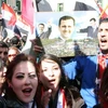 Người dân Syria xuống đường tại thủ đô Damascus bày tỏ sự ủng hộ Tổng thống Bashar al-Assad. (Ảnh: THX/TTXVN)