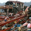 Lực lượng cứu trợ nỗ lực tìm kiếm người sống sót sau động đất và sóng thần tại Miyagi. (Ảnh: AFP/TTXVN)