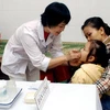 Cho trẻ đi uống vitamin A ở Hà Nội. (Ảnh: Hữu Oai/TTXVN)