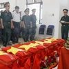 Truy điệu, di chuyển hài cốt liệt sỹ quân tình nguyện Việt Nam hy sinh tại Lào về quê hương. (Ảnh: Thanh Tùng/TTXVN)
