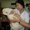 Cháu bé sơ sinh bị bắt cóc được đưa về Bệnh viện C để trao trả cho gia đình. (Nguồn: Vietnam+)
