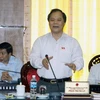 Chủ nhiệm Uỷ ban Pháp luật của Quốc hội Phan Trung Lý trình bày báo cáo về dự án Luật phổ biến, giáo dục pháp luật. (Ảnh: Nguyễn Dân/TTXVN)