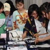 Sinh viên Đại học Đà Nẵng tham gia viết thư pháp Nhật Bản. (Ảnh: Trần Lê Lâm/TTXVN)
