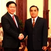 Thủ tướng Lào Thongsin Thammavong tiếp Bộ trưởng Bộ Tài chính Vương Đình Huệ. (Ảnh: Hoàng Chương/Vietnam+) 