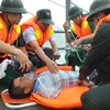 Lực lượng cứu hộ tổ chức cấp cứu cho nạn nhân bị nạn trên biển trong cuộc diễn tập. (Ảnh: Mạnh Khánh/Vietnam+)