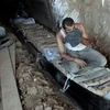 Một người Palestine vận chuyển hàng hóa qua một đường hầm qua biên giới Ai Cập-Gaza ở phía Nam dải Gaza. (Nguồn: presstv.com)