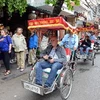 Du khách nước ngoài thăm phố cổ Hà Nội bằng xe xích lô. (Ảnh: Thanh Hà\TTXVN)