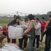 Nhóm tình nguyện trẻ mang chăn ấm đến tặng bà con nơi xóm giữa sông Hồng (Ảnh: Câu lạc bộ Tình nguyện trẻ)