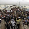 Người tị nạn Syria biểu tình tại khu tị nạn Zaatari gần biên giới với Syria ngày 22/2. (Nguồn: AFP/TTXVN)