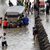 Cảnh ngập lụt ở ngoại ô Manila ngày 14/7. (Ảnh: AFP/TTXVN)