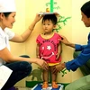 Nhân viên y tế cung cấp dịch vụ dinh dưỡng cho trẻ. (Nguồn: TTXVN)