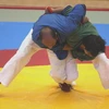 Trận đấu beltwrestling giữa 2 võ sĩ Việt Nam (phải) và Iran (trái). (Ảnh: Tuấn Anh/TTXVN)