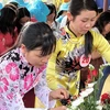 Các tầng lớp phụ nữ Việt Nam nguyện giữ gìn, phát huy truyền thống quý báu của dân tộc, của phụ nữ trong thời kỳ đổi mới. (Ảnh minh họa: Hồ Cầu/TTXVN)