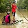 Cảnh ngập lụt tại thị trấn huyện Minh Hóa. (Ảnh: Duy Hưng-Mạnh Thành/TTXVN)