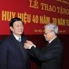 Tổng Bí thư Nguyễn Phú Trọng gắn Huy hiệu 40 năm tuổi Đảng cho Ủy viên Bộ Chính trị, Thường trực Ban Bí thư Trương Tấn Sang. (Ảnh: Thống Nhất/TTXVN)