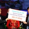 Thành phố Hà Nội ủng hộ Quỹ vì người nghèo 300 tỷ đồng tại điểm cầu Hà Nội. Ảnh : Nguyễn Dân - TTXVN