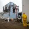 Công nhân phun nước làm mát tại lò phản ứng số 4 nhà máy điện hạt nhân Fukushima 1 ngày 22/3. (Nguồn: AFP/TTXVN)