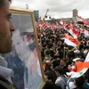 Tuần hành ủng hộ Chính phủ Xyri tại Damascus ngày 15/3. (Nguồn: THX/TTXVN)
