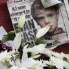 Một tờ báo đăng hình bé trai 6 tuổi Etan Patz cùng những bông hoa tưởng niệm cậu bé tại SoHo ngày 28/5. (Nguồn: AP)