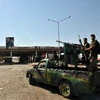 Các binh sỹ lực lượng nổi dậy Syria sau khi giành quyền kiểm soát bốt đóng quân ở Bab el Hawa, gần cửa khẩu Cilvegozu thuộc tỉnh Hatay (Thổ Nhĩ Kỳ). (Nguồn: AFP/TTXVN)
