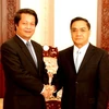Thủ tướng Lào Thongsin Thammavong tiếp ông Hoàng Dân Mạc. (Ảnh: Hoàng Chương/Vietnam+)