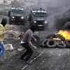 Người biểu tình Palestine ném đá vào binh sỹ Israel tại làng Kufr Qadoom. (Nguồn: THX/TTXVN)
