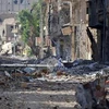 Cảnh đổ nát sau các cuộc giao tranh giữa quân chính phủ và lực lượng nổi dậy tại trung tâm thành phố Deir Ezzor, đông bắc Syria ngày 27/6. (Nguồn: AFP/TTXVN)