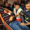 Một nhà báo bị thương trong vụ không kích của Israel vào tòa nhà kênh truyền hình al-QudsGada . (Nguồn: AFP/TTXVN)