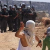 Những người biểu tình Palestine ném đá vào binh sỹ Israel trong vụ xung đột ở làng Qasra, gần Nablus ngày 16/9. (Nguồn: THX/TTXVN)