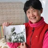 Bà Vương Phong và bức ảnh quý chụp với Bác Hồ khi xưa. Ảnh: Xuân Vịnh/Vietnam+) 