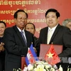Bộ trưởng Quốc phòng Việt Nam-Campuchia trao đổi văn bản Kế hoạch hợp tác năm 2013 vừa được ký kết. (Ảnh: Thế Anh/TTXVN)